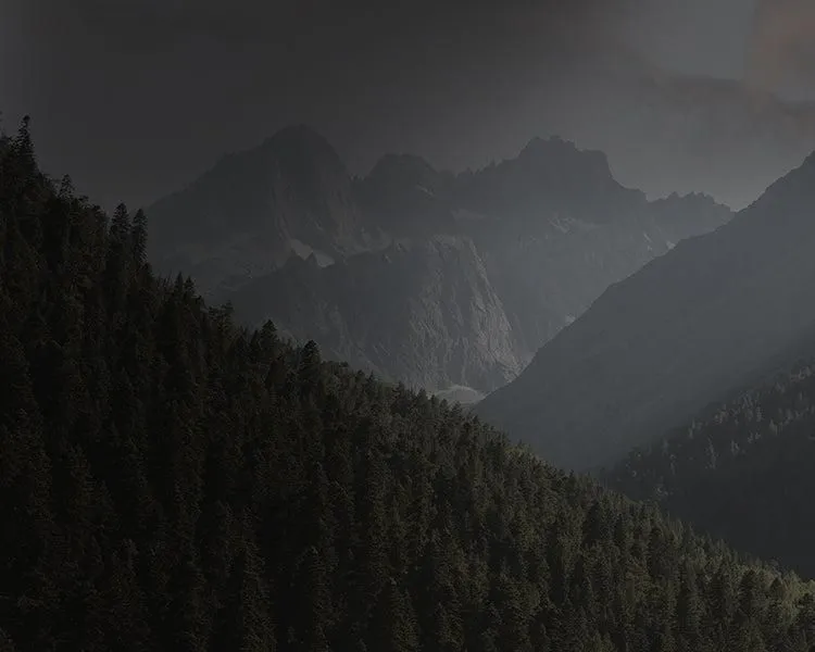 A dark Alaskan ridge line under low cloud