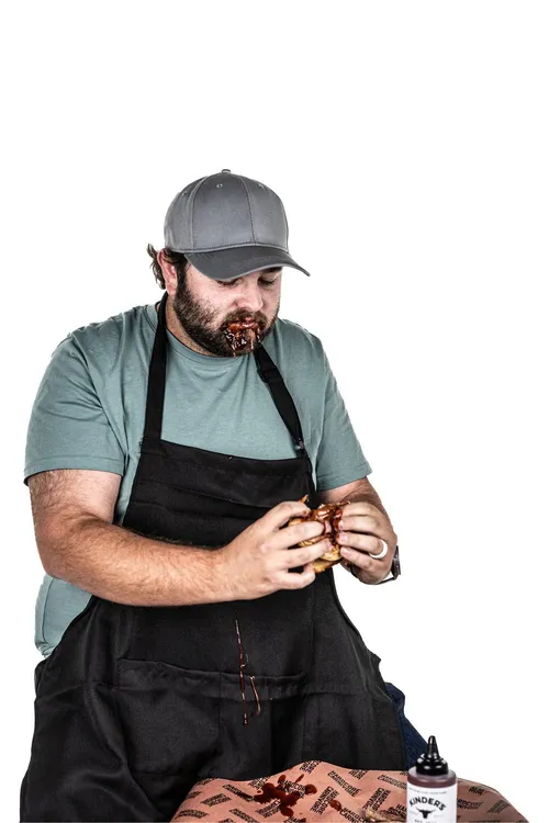A Groove Life team member in a cap and work apron
