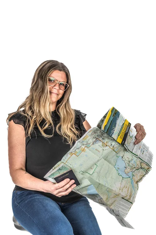 A Groove Life team member unfolding a paper trail map