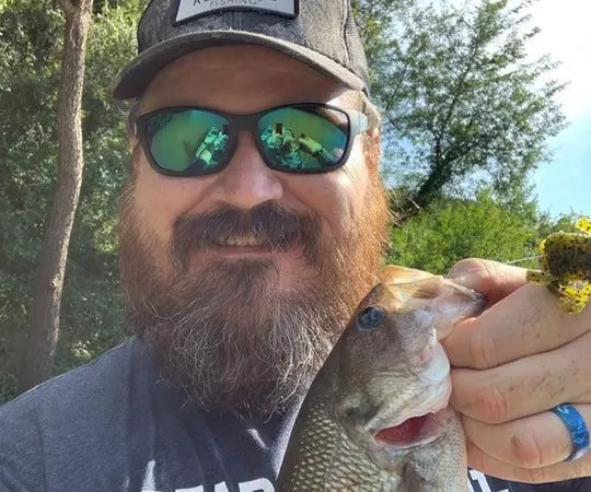 Justin Martin holds a fish up to the camera